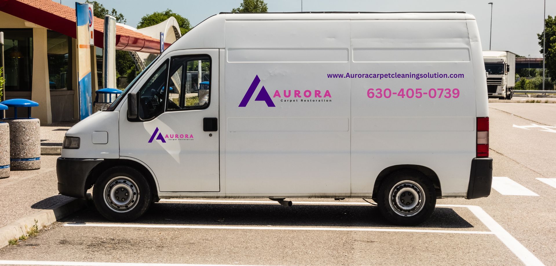 A white van parked in a parking lot, associated with a carpet and rug cleaning service in Aurora, Colorado.